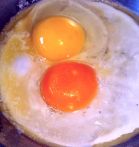 the difference in egg color is stunning. Which one is the "standard" store-purchased egg, and which is the backyard chicken egg. Can you tell?